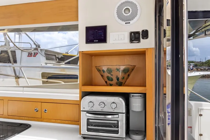Slide: The Image of Modern kitchen area on 2023 ArrowCat 420 Flybridge with appliances and decorative bowl. - 44
