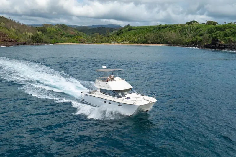 Slide: The Image of 2023 ArrowCat 420 Flybridge cruising in scenic coastal waters. - 5