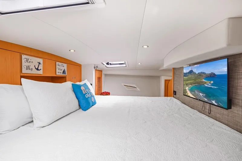Slide: The Image of Luxurious 2023 ArrowCat 420 Flybridge cabin with cozy bedding and wall-mounted TV. - 50