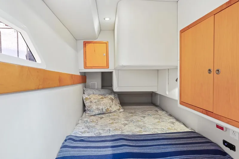 Slide: The Image of Cozy cabin interior of 2023 ArrowCat 420 Flybridge with bed and wooden cabinets. - 51