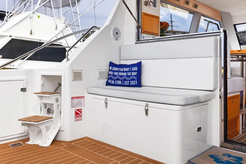 Slide: The Image of 2023 ArrowCat 420 Flybridge interior with seating, cushion, and wooden steps. - 56