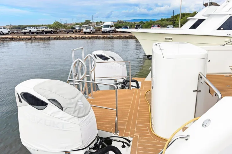 Slide: The Image of 2023 ArrowCat 420 Flybridge with Suzuki engines docked at marina, showcasing sleek design. - 60