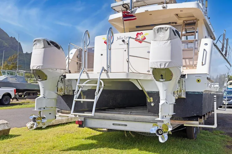 Slide: The Image of 2023 ArrowCat 420 Flybridge boat with dual outboard motors on a trailer. - 69