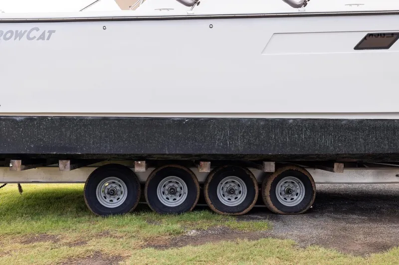 Slide: The Image of 2023 ArrowCat 420 Flybridge on trailer, side view showing wheels and hull. - 75