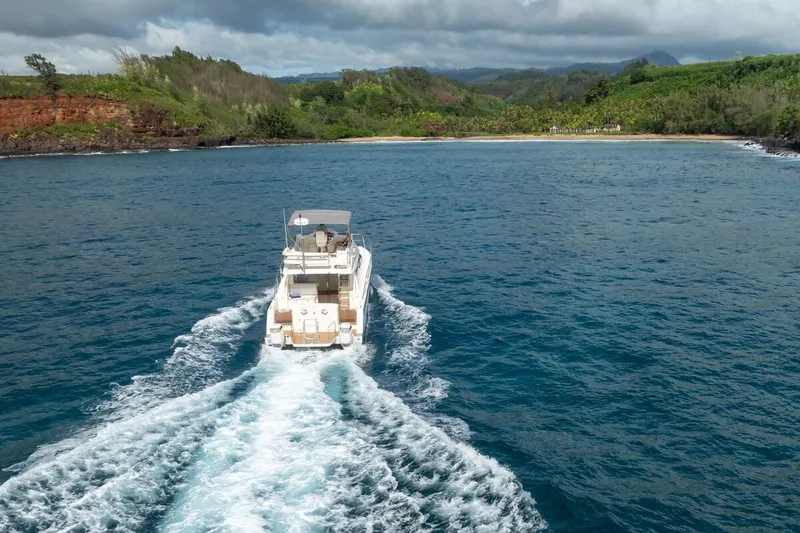 Slide: The Image of 2023 ArrowCat 420 Flybridge cruising near a scenic coastline. - 9