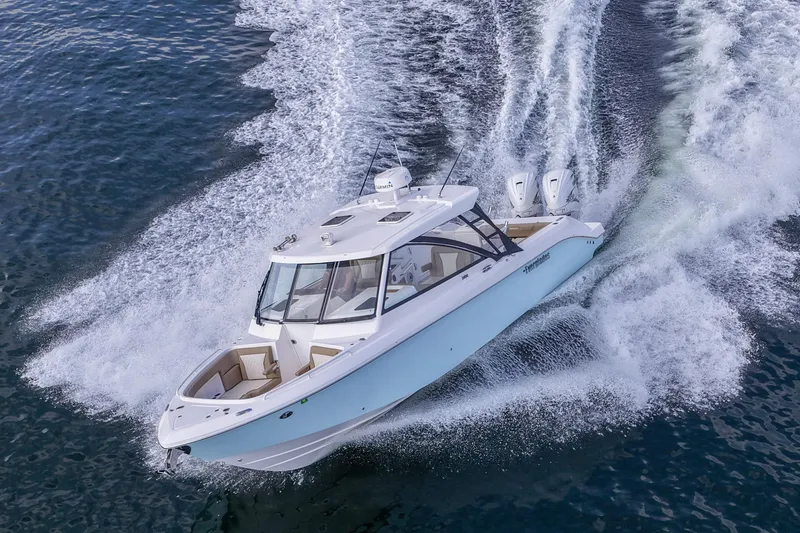 The Image of 2023 Everglades 340 Dual Console boat on calm water, showcasing sleek design and modern features. - 0