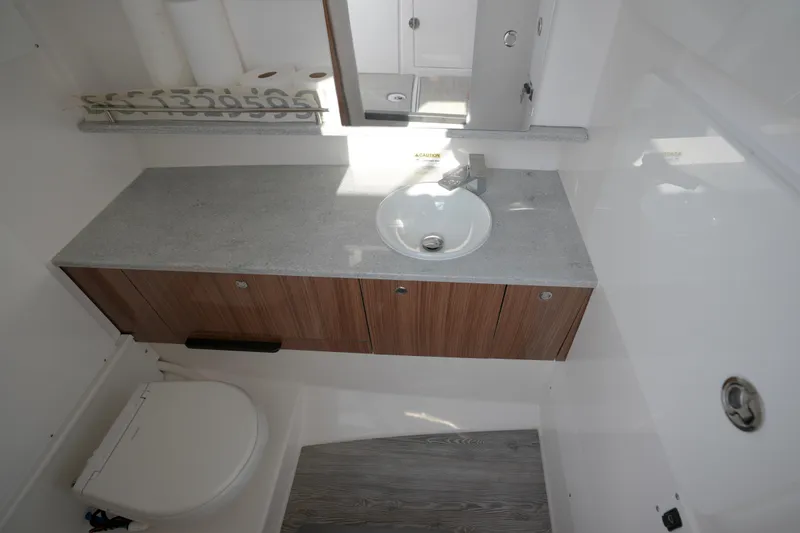 Slide: The Image of Twin V8 engines powering a 2023 Everglades 340 Dual Console boat on open water. - 16