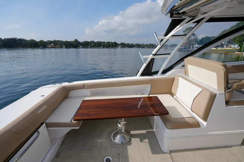 Slide: The Image of 2023 Everglades 340 Dual Console boat cruising on water, featuring Yamaha engines. - 2