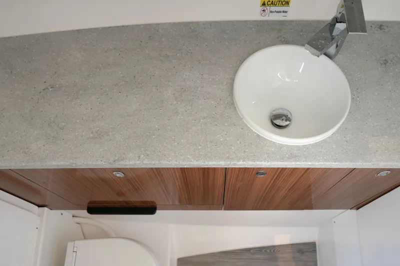 Slide: The Image of 2023 Everglades 340 Dual Console bathroom with wooden cabinets and modern sink. - 22