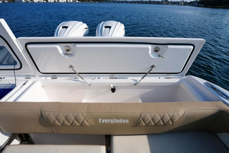Slide: The Image of 2023 Everglades 340 Dual Console boat on water, featuring spacious seating and modern amenities. - 28