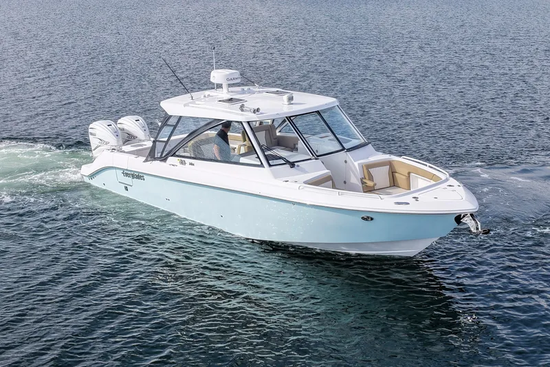 Slide: The Image of Livewell compartment on 2023 Everglades 340 Dual Console boat, featuring a blue interior. - 30