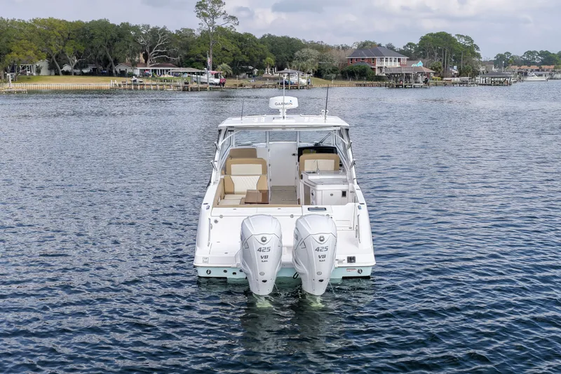 Slide: The Image of 2023 Everglades 340 Dual Console boat on water, featuring twin Yamaha 425 engines. - 33