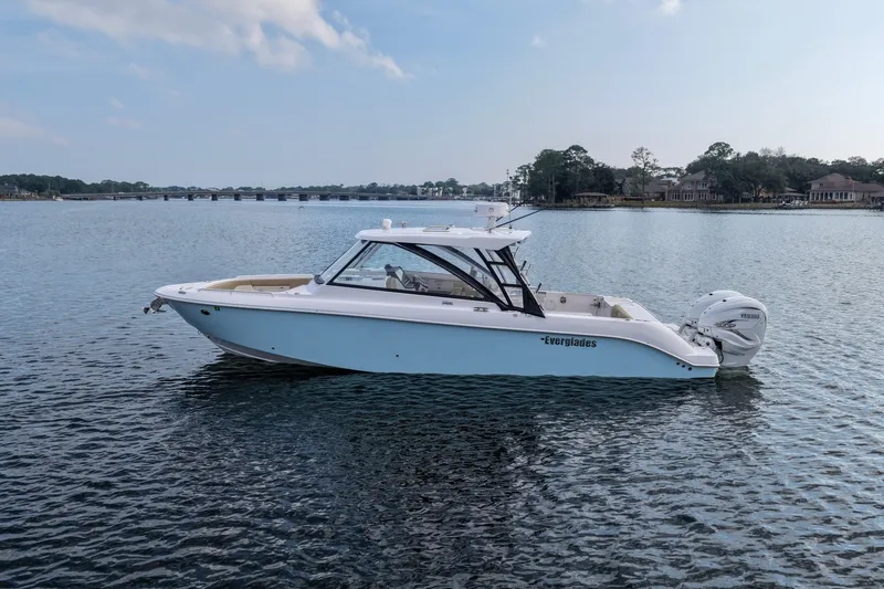 Slide: The Image of 2023 Everglades 340 Dual Console boat on calm water with Yamaha engines. - 35