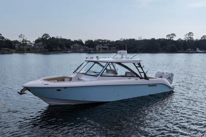 Slide: The Image of 2023 Everglades 340 Dual Console boat on calm water, showcasing sleek design and modern features. - 36