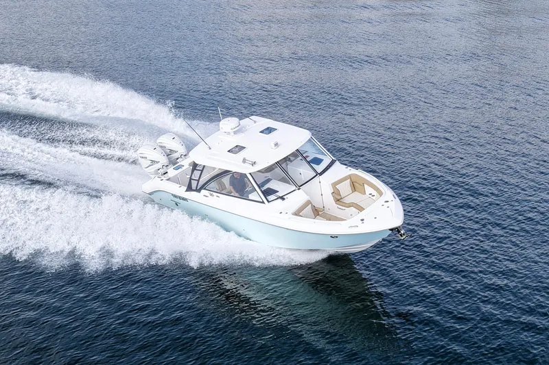 Slide: The Image of 2023 Everglades 340 Dual Console boat cruising on open water. - 41