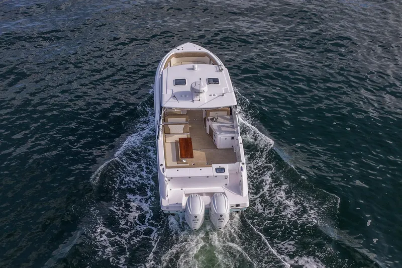 Slide: The Image of 2023 Everglades 340 Dual Console boat cruising on open water, aerial view. - 43