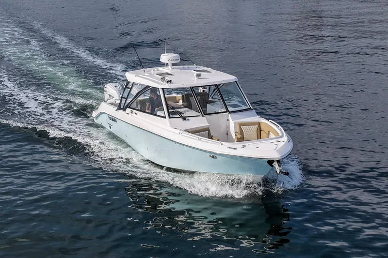 Slide: The Image of 2023 Everglades 340 Dual Console boat cruising on open water. - 44