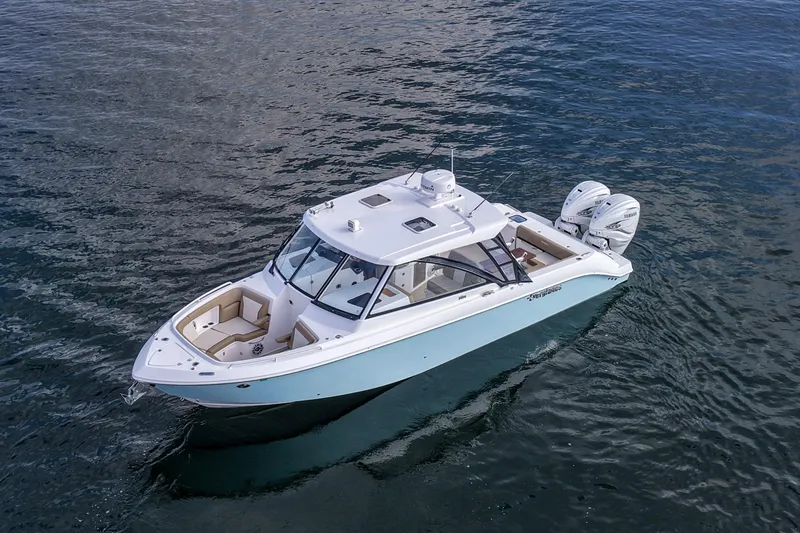 Slide: The Image of 2023 Everglades 340 Dual Console boat on calm water, featuring twin engines. - 46