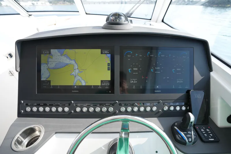 Slide: The Image of 2023 Everglades 340 Dual Console boat helm with advanced navigation displays and controls. - 5