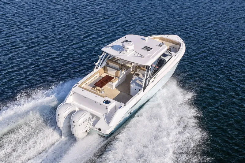 Slide: The Image of 2023 Everglades 340 Dual Console boat cruising on open water. - 51