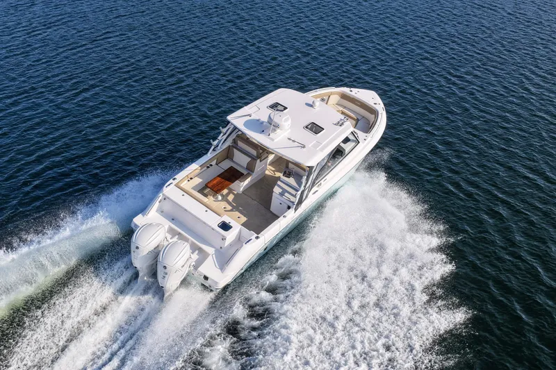 Slide: The Image of 2023 Everglades 340 Dual Console boat cruising on open water. - 52