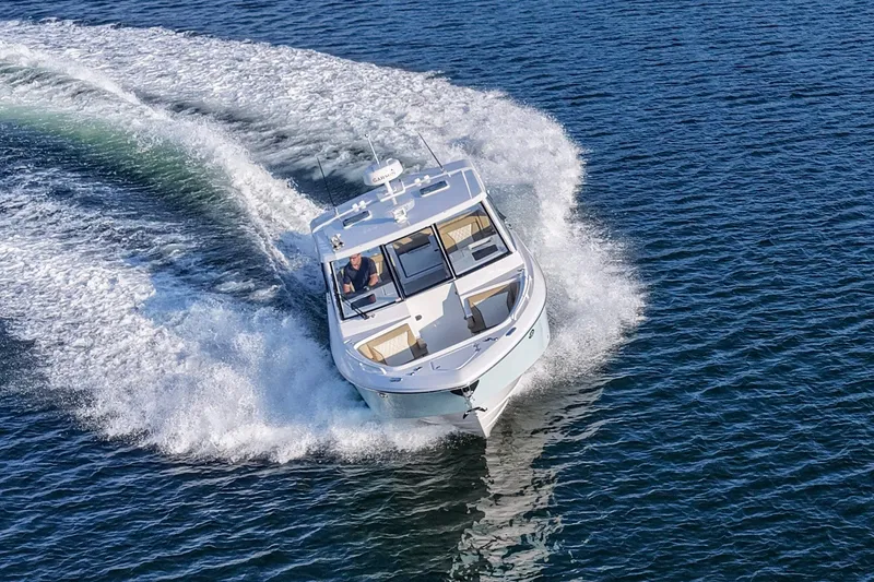 Slide: The Image of 2023 Everglades 340 Dual Console boat cruising on open water. - 53