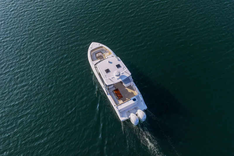 Slide: The Image of Aerial view of 2023 Everglades 340 Dual Console boat cruising on open water. - 57