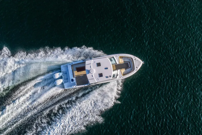 Slide: The Image of Aerial view of 2023 Everglades 340 Dual Console boat cruising on open water. - 58