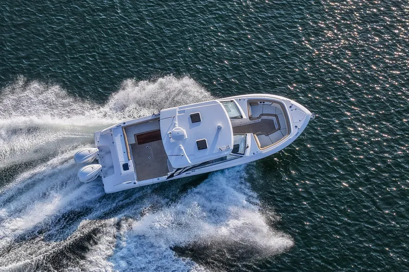 Slide: The Image of Aerial view of 2023 Everglades 340 Dual Console boat cruising on water. - 59