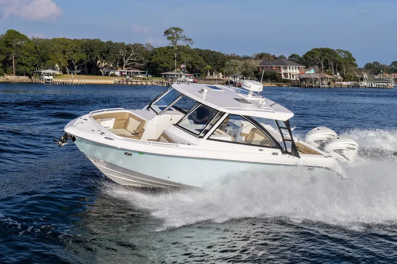 Slide: The Image of 2023 Everglades 340 Dual Console boat cruising on a scenic waterway. - 63