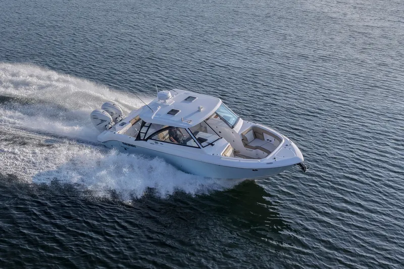 Slide: The Image of 2023 Everglades 340 Dual Console boat cruising on open water. - 68