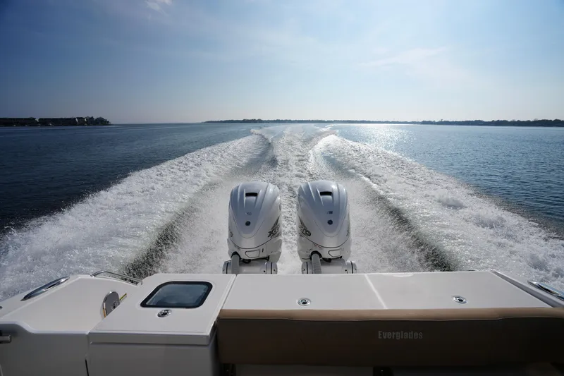 Slide: The Image of 2023 Everglades 340 Dual Console boat interior with scenic water view. - 9