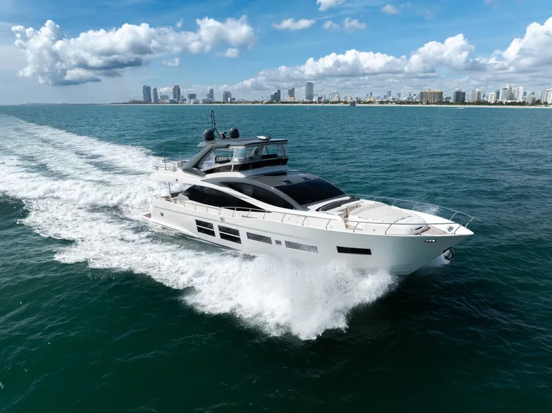 Slide: The Image of Astondoa 80 GLX 2016 yacht cruising on open water with city skyline backdrop. - 11