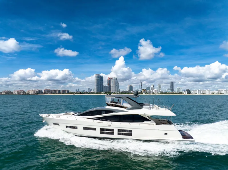 Slide: The Image of Astondoa 80 GLX 2016 yacht cruising on blue ocean with city skyline backdrop. - 14