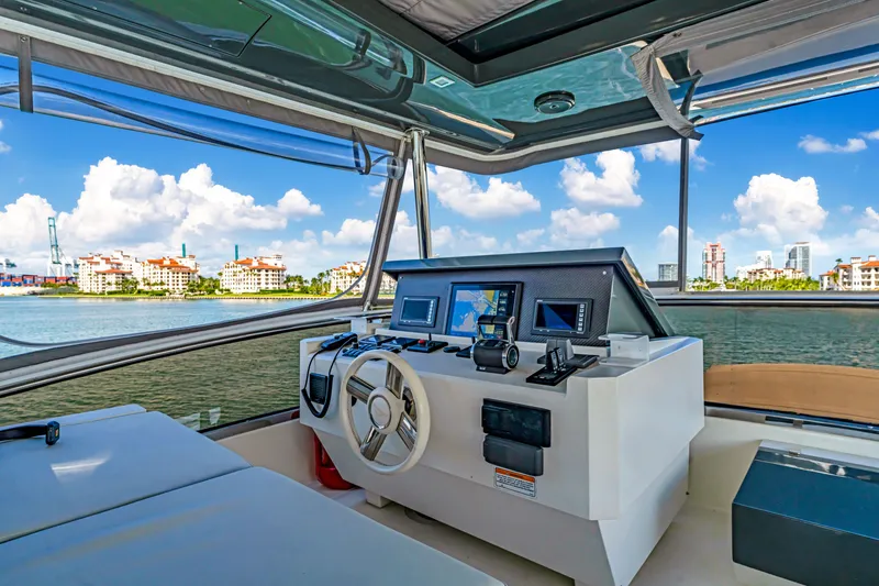 Slide: The Image of Luxurious 2016 Astondoa 80 GLX yacht helm with modern navigation equipment and scenic waterfront view. - 36
