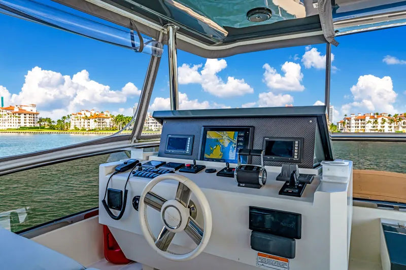 Slide: The Image of Astondoa 80 GLX 2016 yacht helm with navigation equipment, overlooking scenic waterfront. - 37