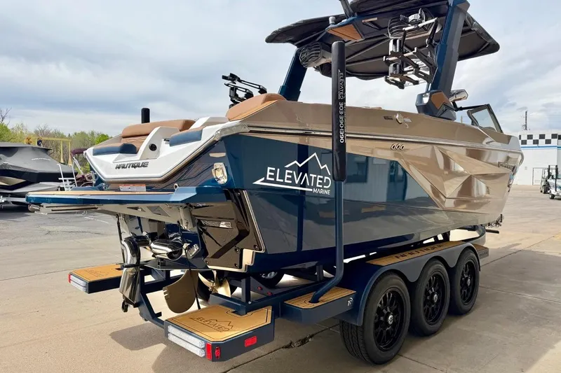 Slide: The Image of 2026 Nautique Super Air Nautique G23 boat on trailer, displayed outdoors. - 11