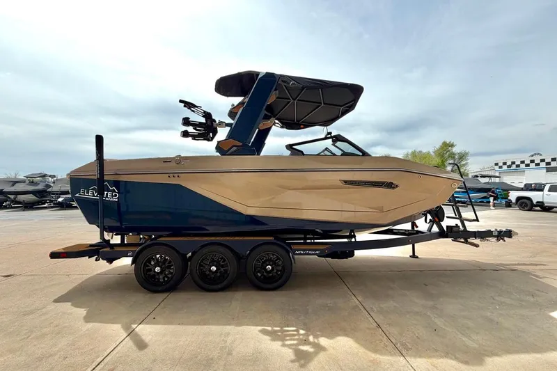 Slide: The Image of 2026 Nautique Super Air Nautique G23 boat on trailer, side view. - 12