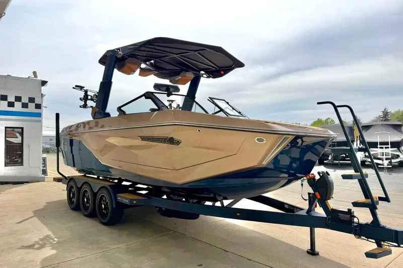 Slide: The Image of 2026 Nautique Super Air Nautique G23 boat on trailer, parked outdoors. - 13