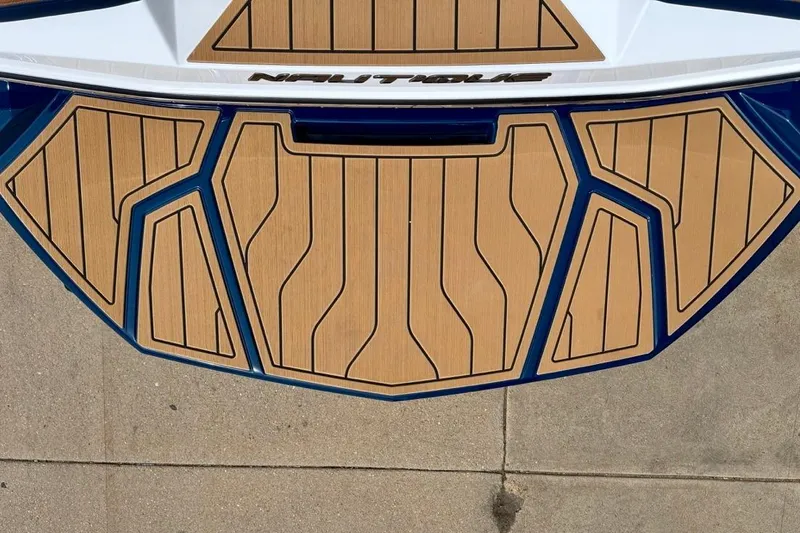 Slide: The Image of 2026 Nautique Super Air Nautique G23 swim platform with teak-style decking. - 14