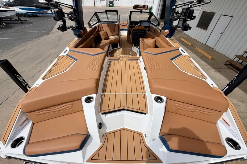 Slide: The Image of 2026 Nautique Super Air Nautique G23 boat with luxurious tan seating and sleek design. - 15