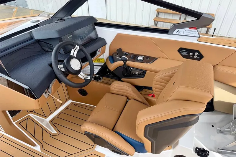 Slide: The Image of 2026 Nautique Super Air Nautique G23 cockpit with tan leather seats and modern dashboard. - 17