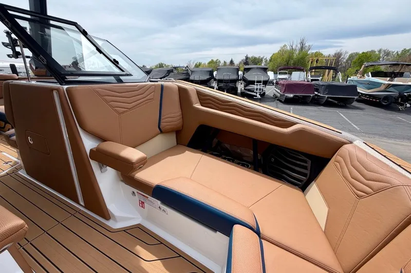 Slide: The Image of 2026 Nautique Super Air Nautique G23 interior with tan leather seating and modern design. - 23