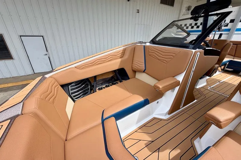 Slide: The Image of 2026 Nautique Super Air Nautique G23 interior with tan leather seating and sleek design. - 24