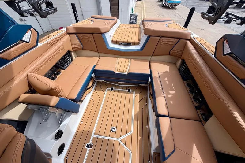 Slide: The Image of Luxurious interior of 2026 Nautique Super Air Nautique G23 boat with tan seating. - 27