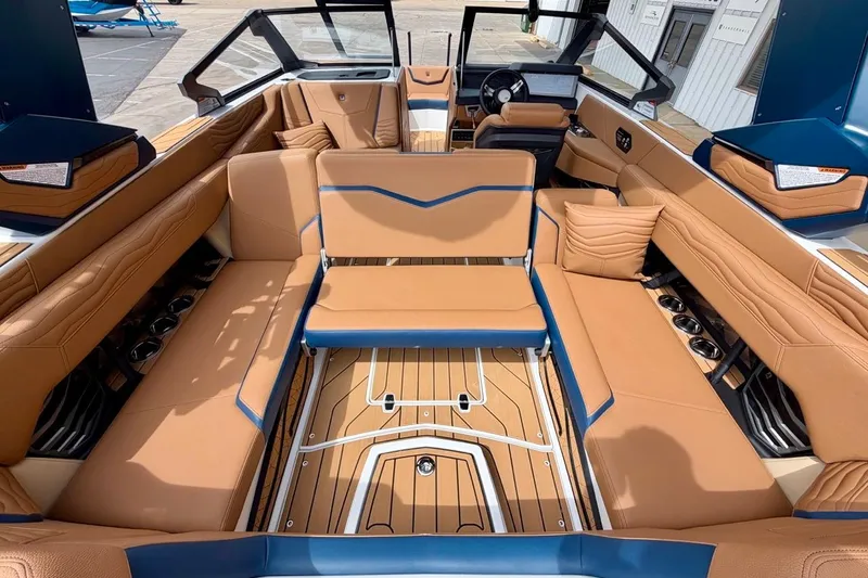 Slide: The Image of Luxurious interior of 2026 Nautique Super Air Nautique G23 with tan and blue seating. - 28