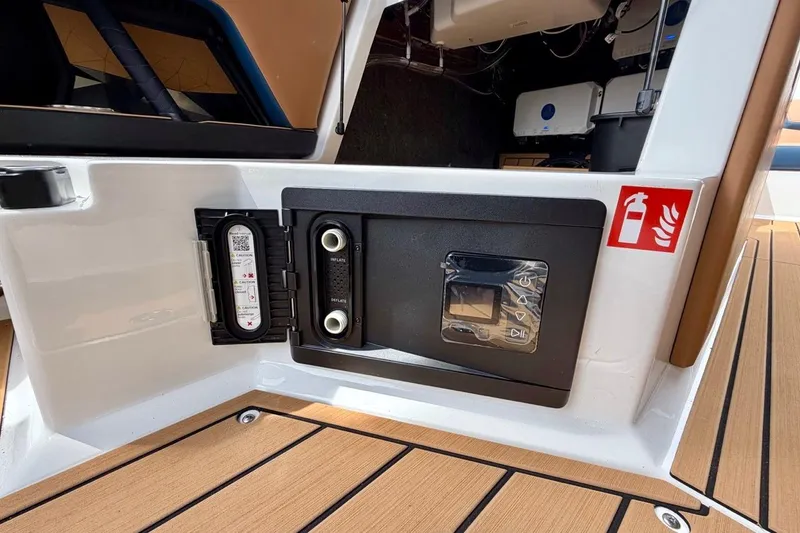 Slide: The Image of 2026 Nautique Super Air Nautique G23 boat interior with safety equipment and control panel. - 30