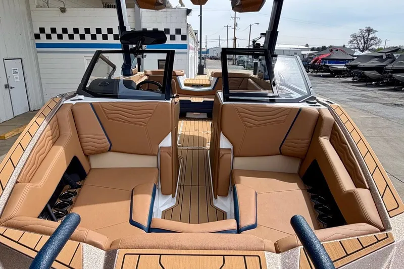 Slide: The Image of 2026 Nautique Super Air Nautique G23 boat interior with tan seating and sleek design. - 7