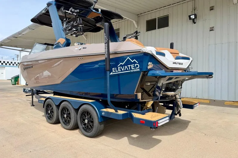 Slide: The Image of 2026 Nautique Super Air Nautique G23 boat on trailer, displayed outdoors. - 8