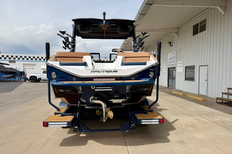 Slide: The Image of 2026 Nautique Super Air Nautique G23 boat, rear view at a service entrance. - 9